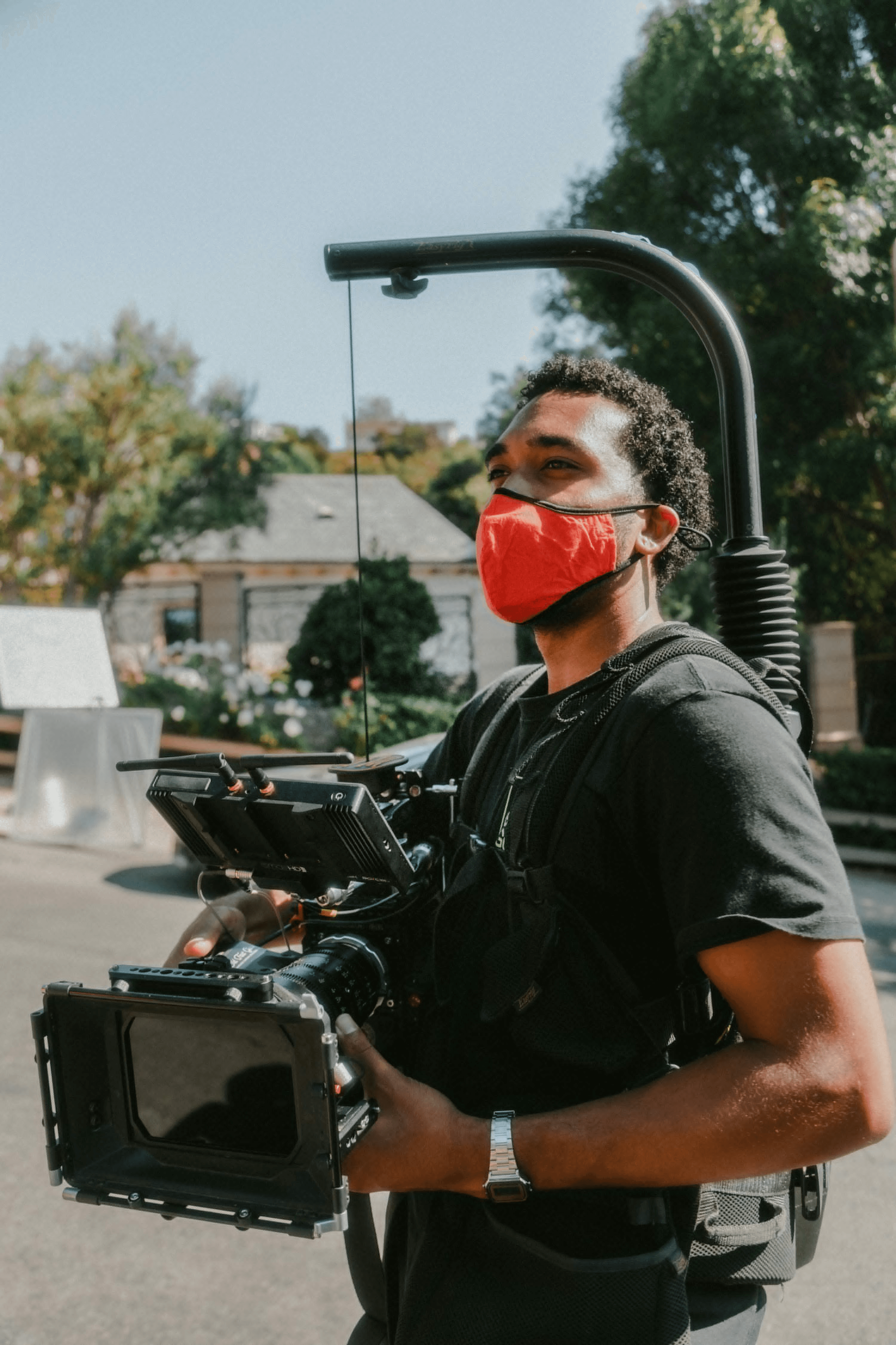 Film production scene with camera operator wearing a red mask