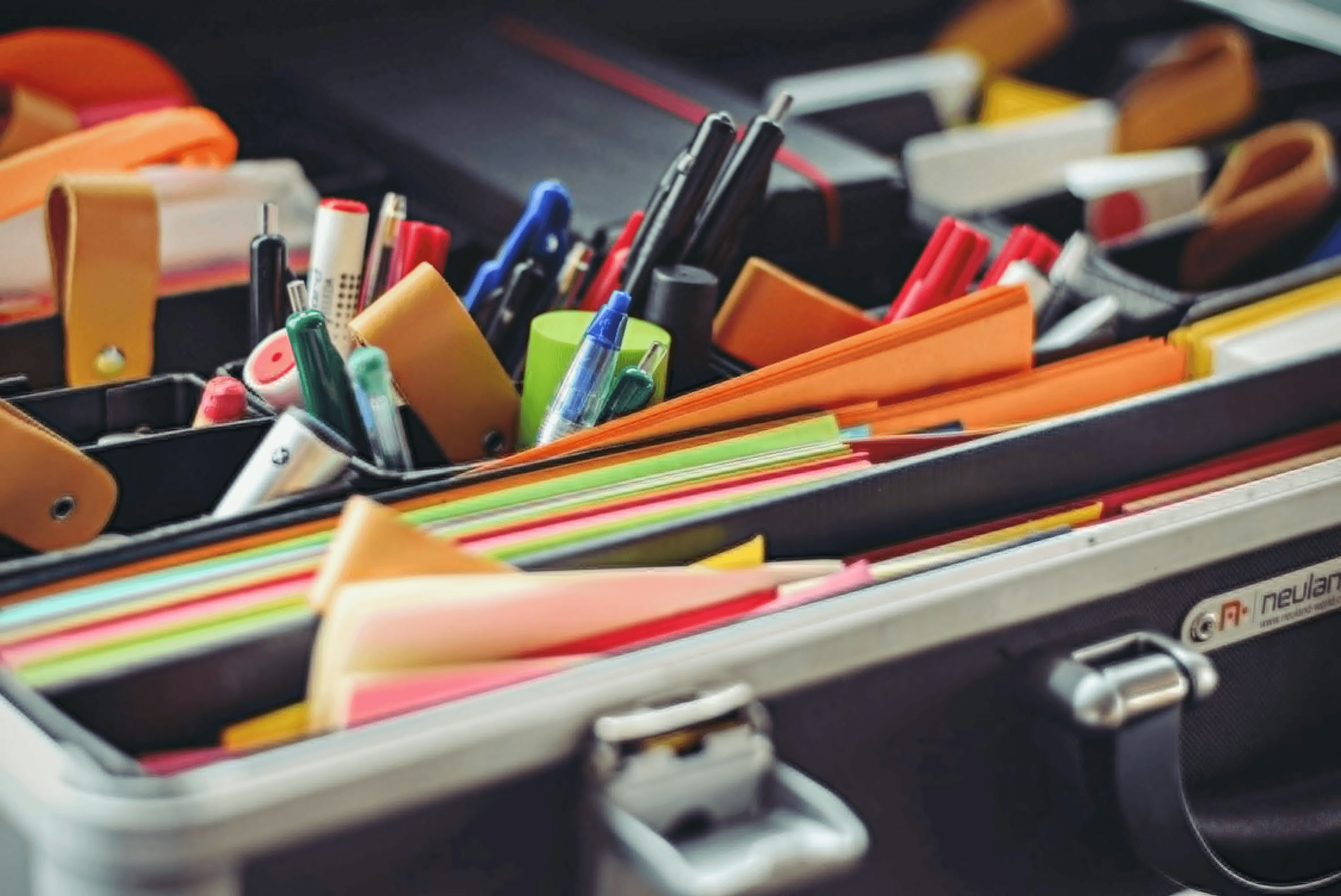 Various stationery items including pens, folders and papers